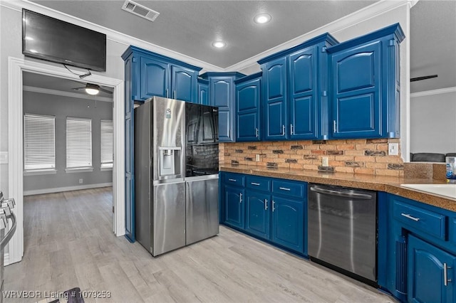 kitchen featuring blue cabinetry, visible vents, stainless steel appliances, and crown molding