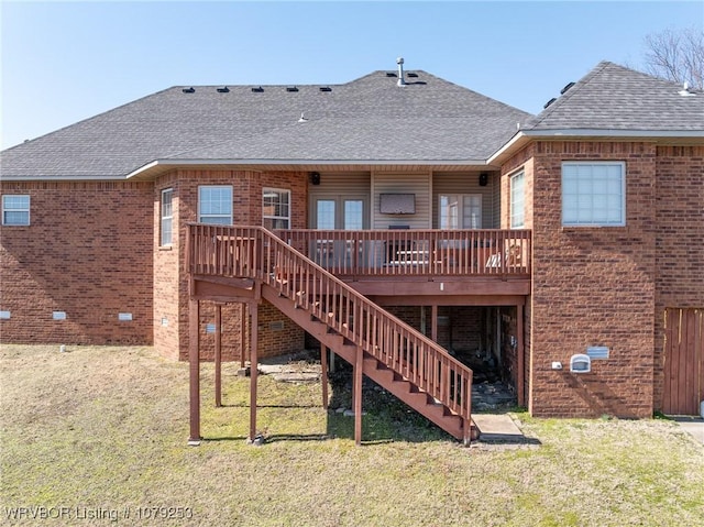 back of house featuring brick siding, a yard, stairway, roof with shingles, and a wooden deck