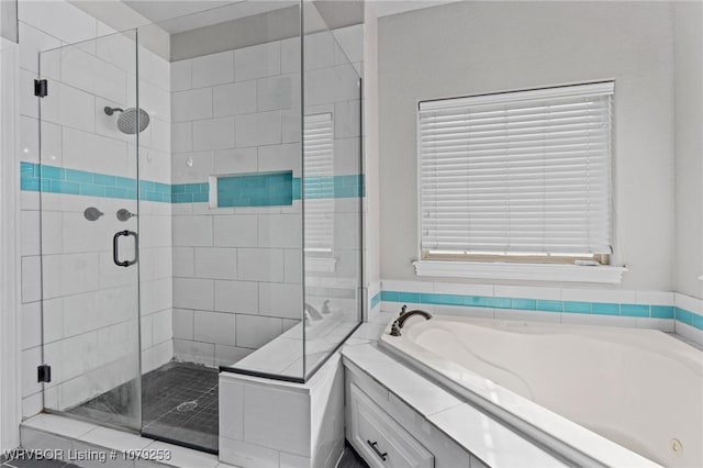 full bathroom featuring a garden tub and a shower stall