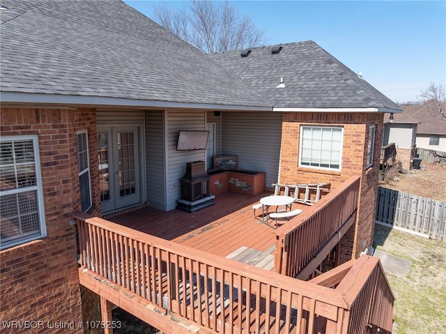 wooden deck featuring fence and french doors