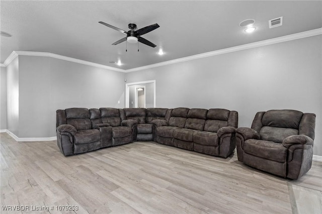 living area featuring baseboards, visible vents, ceiling fan, ornamental molding, and light wood-type flooring