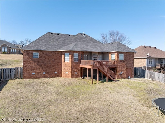 rear view of house featuring a deck, a fenced backyard, brick siding, stairs, and crawl space