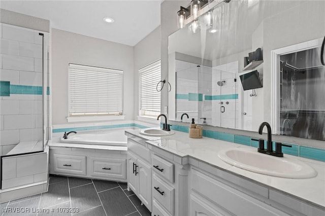 full bathroom featuring double vanity, a stall shower, a sink, and tile patterned floors