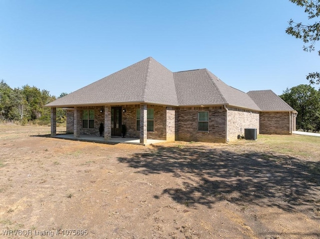 view of front of house with a patio and central AC unit