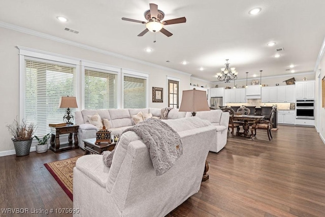 living room featuring ceiling fan with notable chandelier, dark hardwood / wood-style floors, and ornamental molding