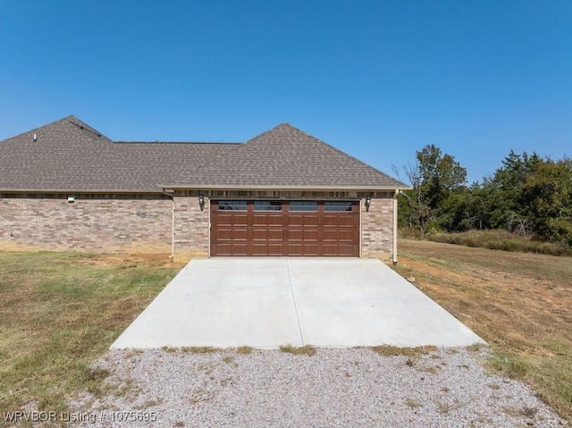 view of front facade with a garage and a front lawn