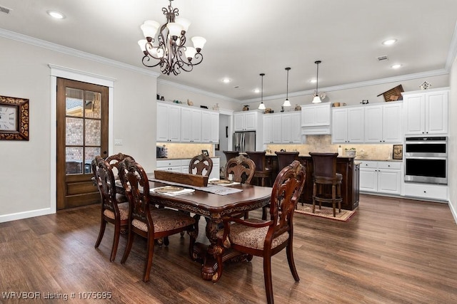 dining room featuring crown molding, dark hardwood / wood-style flooring, and an inviting chandelier