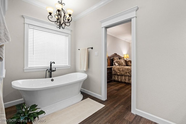 bathroom featuring hardwood / wood-style flooring, a bathtub, a chandelier, and ornamental molding