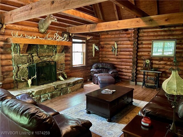 living room with a fireplace, wooden ceiling, hardwood / wood-style floors, and lofted ceiling with beams