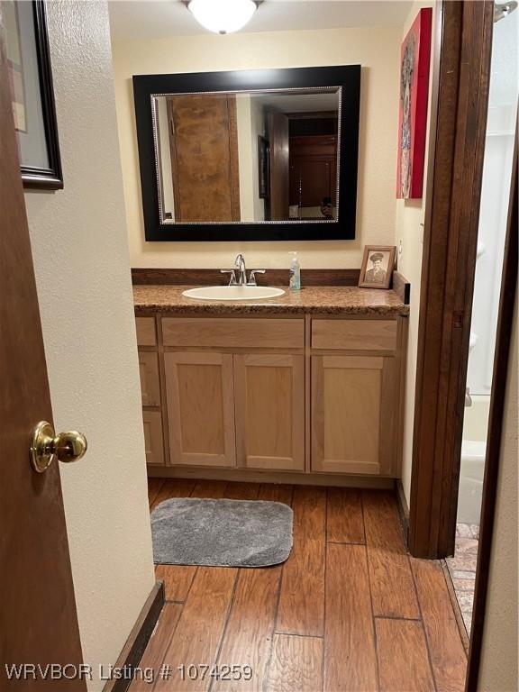 bathroom with wood-type flooring and vanity