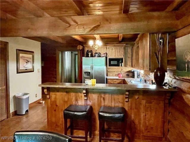 bar featuring stainless steel fridge, wood ceiling, black microwave, sink, and an inviting chandelier