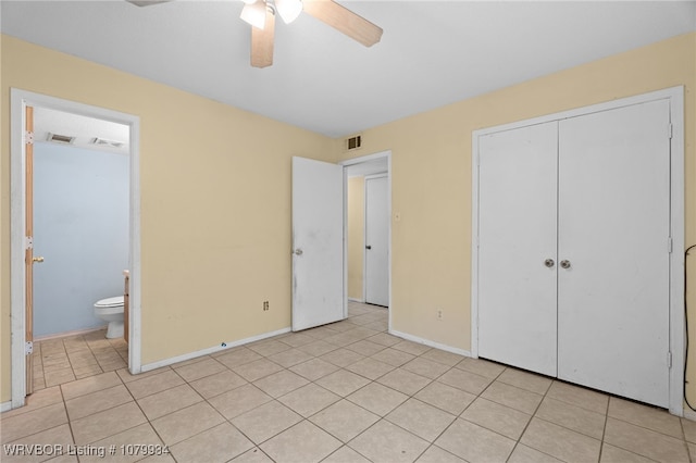 unfurnished bedroom featuring light tile patterned floors, baseboards, a closet, and visible vents