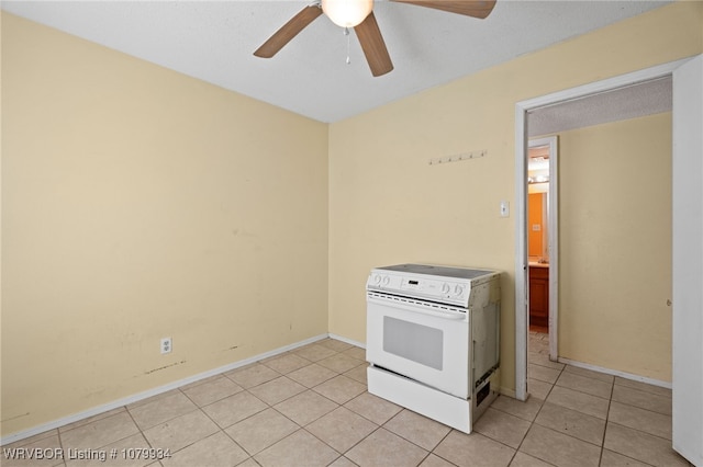 kitchen with a ceiling fan, light tile patterned floors, baseboards, and electric stove