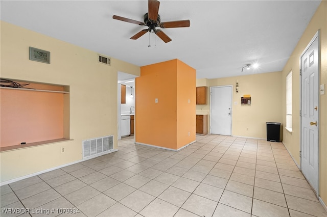 unfurnished room with visible vents, light tile patterned floors, and a ceiling fan
