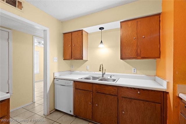 kitchen with light countertops, a sink, dishwasher, light tile patterned floors, and visible vents