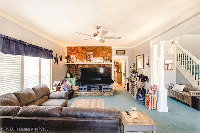 carpeted living room featuring ornamental molding, stairway, ornate columns, and a ceiling fan