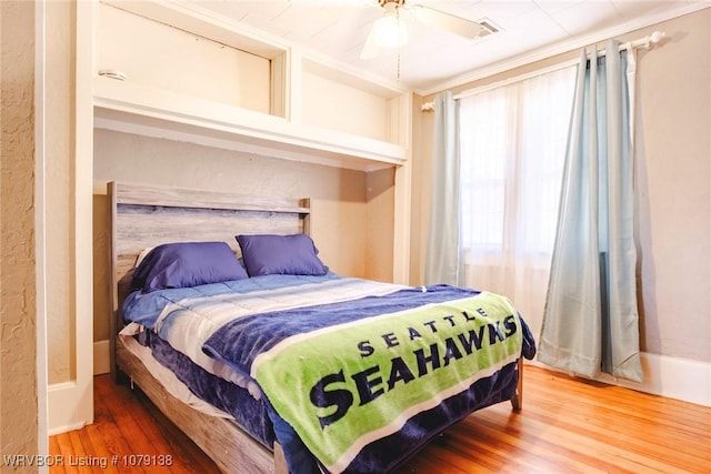 bedroom featuring a ceiling fan and wood finished floors