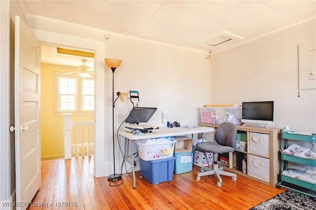 office area with ornamental molding, wood finished floors, and attic access