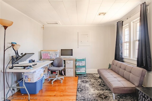 office space featuring visible vents, wood finished floors, and ornamental molding