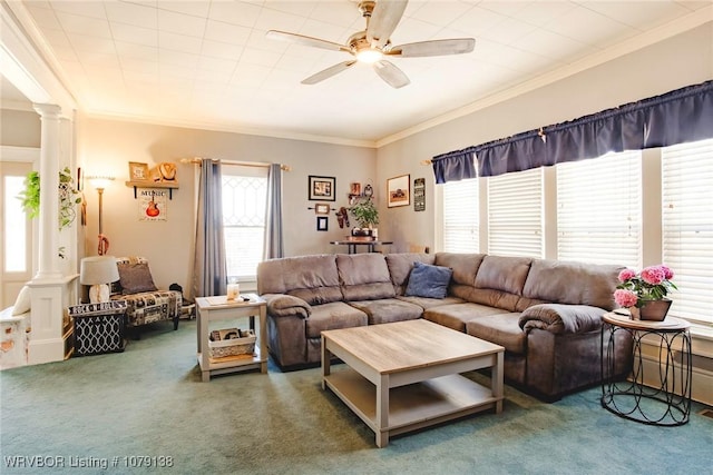 living area with a ceiling fan, decorative columns, dark carpet, and crown molding