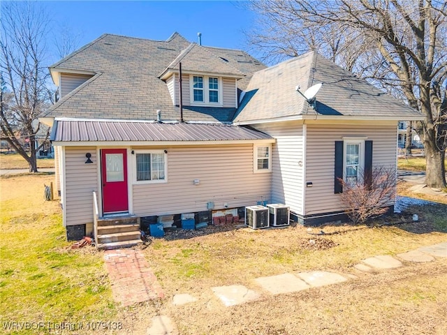 rear view of property featuring entry steps and cooling unit