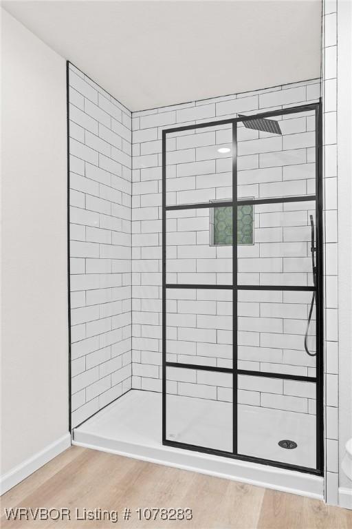 48 W Gary St, Greenwood, AR 72936 - bathroom featuring hardwood / wood-style floors and a shower with door