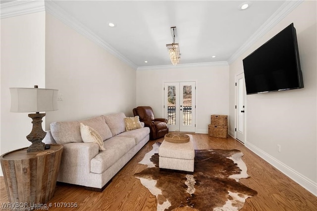 living area featuring french doors, recessed lighting, ornamental molding, wood finished floors, and baseboards