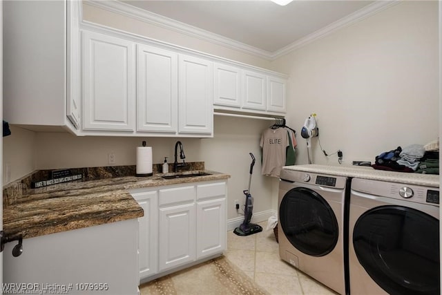 laundry room with crown molding, light tile patterned floors, cabinet space, a sink, and washer and dryer