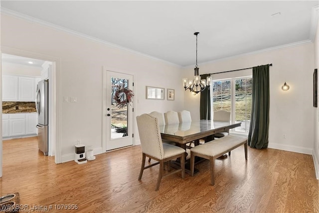 dining area with light wood-type flooring and crown molding