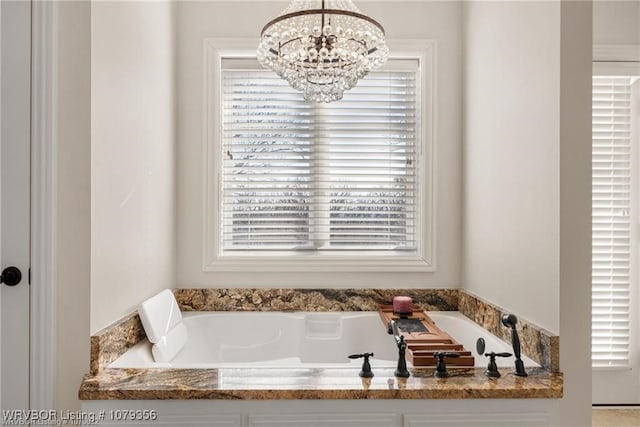 full bath with a chandelier and a garden tub