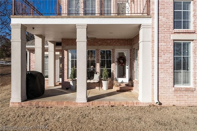 view of patio / terrace featuring a grill and a balcony