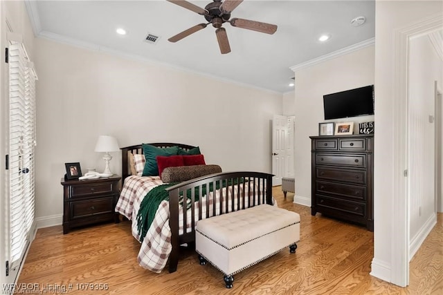 bedroom featuring light wood-type flooring, baseboards, and ornamental molding