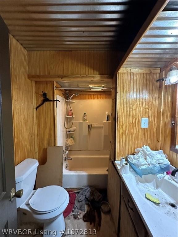 full bathroom with vanity, wood walls, toilet, and shower / bathtub combination