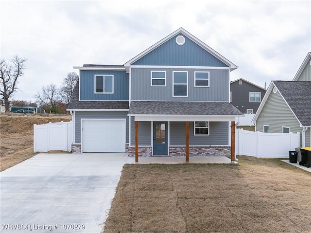 view of front of house with a porch, a garage, and a front lawn