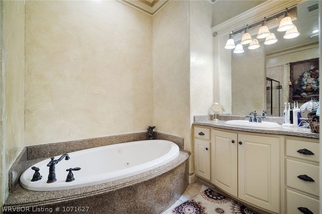 bathroom with tiled bath, vanity, and ornamental molding