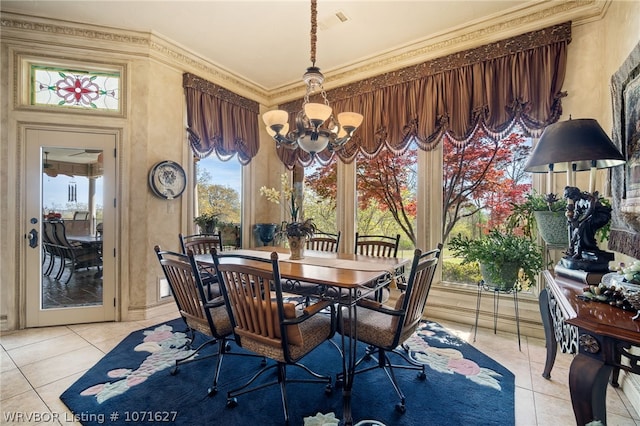 dining room with a chandelier, ornamental molding, and light tile patterned flooring