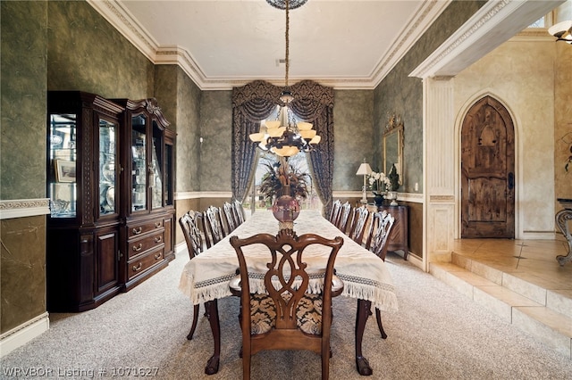 carpeted dining space with ornamental molding and a notable chandelier