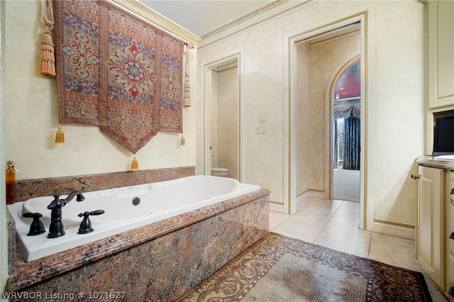 bathroom with tiled tub, toilet, tile patterned flooring, and ornamental molding