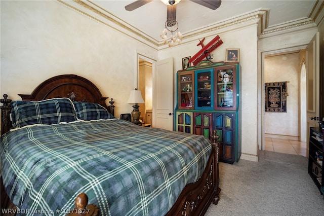 bedroom with ceiling fan, carpet floors, and ornamental molding