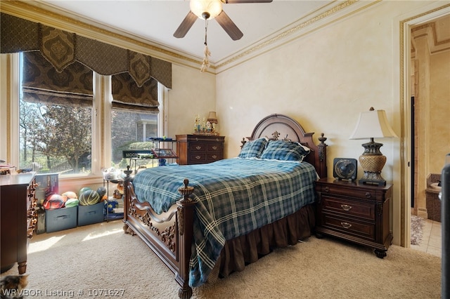 bedroom featuring ceiling fan, crown molding, and light carpet