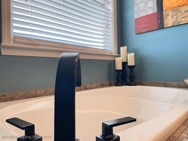 527 Polk Road 59, Mena, AR 71953 - bathroom featuring a garden tub and a sink