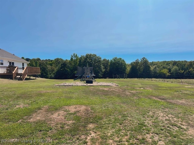 527 Polk Road 59, Mena, AR 71953 - view of grassy yard with a wooden deck and a view of trees