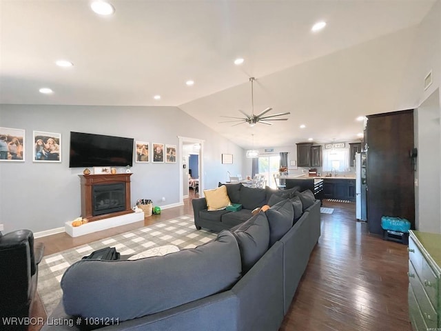 527 Polk Road 59, Mena, AR 71953 - living room featuring vaulted ceiling, a glass covered fireplace, dark wood-type flooring, a ceiling fan, and recessed lighting