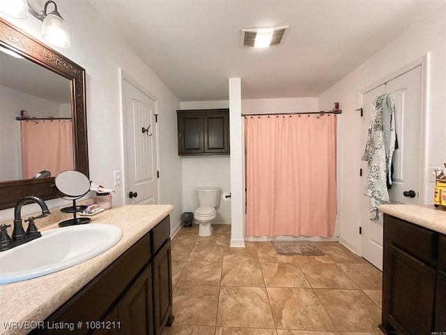 527 Polk Road 59, Mena, AR 71953 - full bathroom with vanity, toilet, a shower with shower curtain, tile patterned flooring, and baseboards