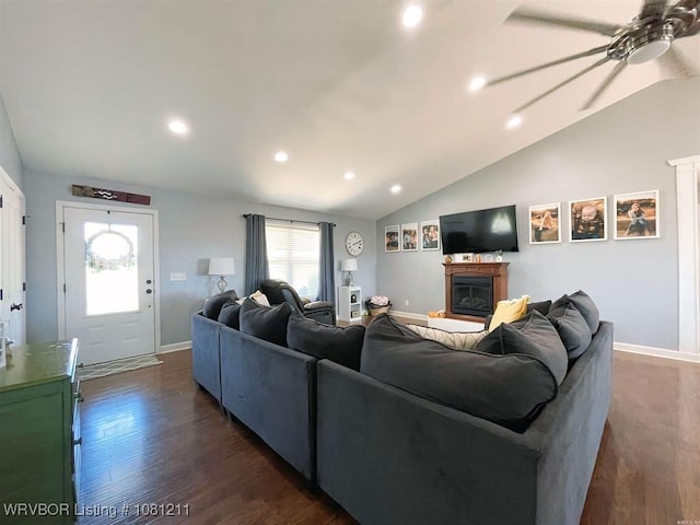 527 Polk Road 59, Mena, AR 71953 - living room featuring a glass covered fireplace, vaulted ceiling, a ceiling fan, dark wood-style flooring, and baseboards