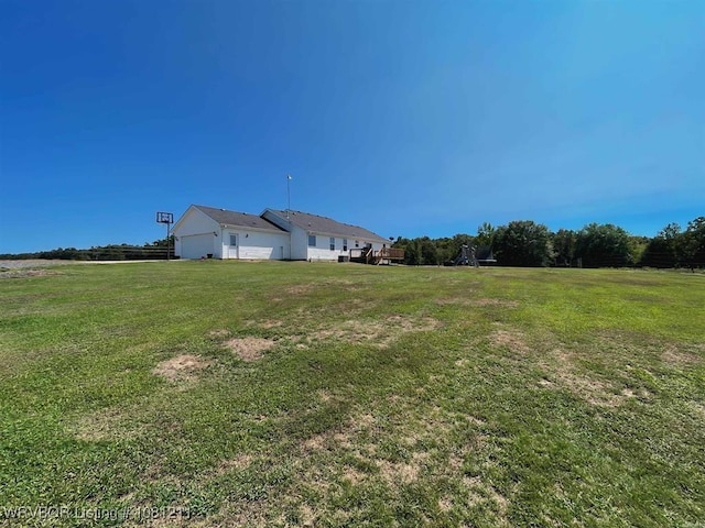 527 Polk Road 59, Mena, AR 71953 - view of grassy yard with an attached garage