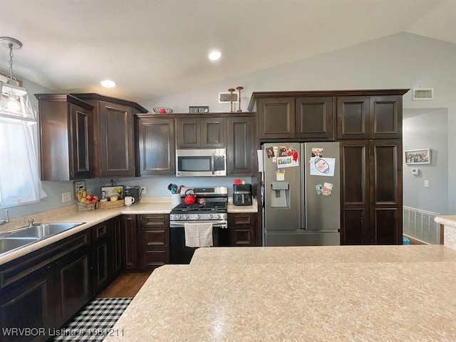 527 Polk Road 59, Mena, AR 71953 - kitchen with appliances with stainless steel finishes, vaulted ceiling, dark brown cabinetry, light countertops, and a sink