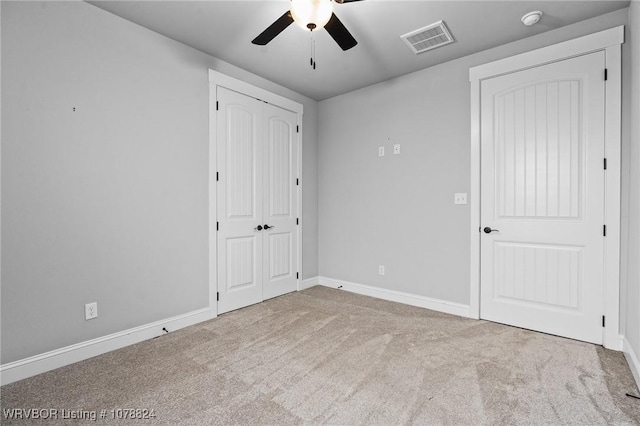 unfurnished bedroom featuring ceiling fan and light carpet