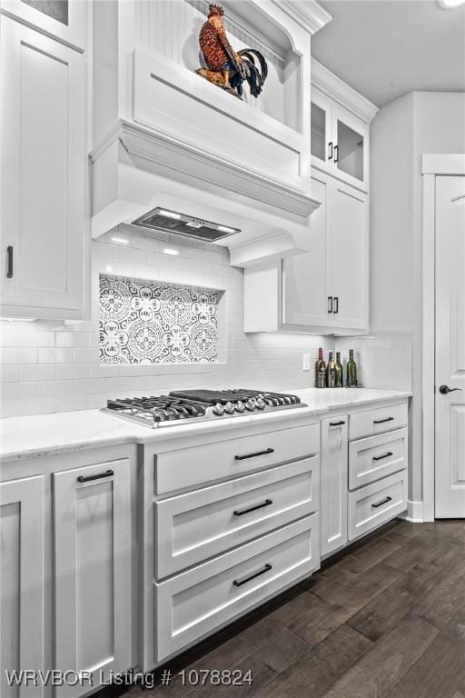 kitchen featuring white cabinetry, tasteful backsplash, stainless steel gas stovetop, and custom range hood