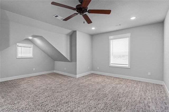 additional living space featuring vaulted ceiling, carpet floors, and ceiling fan